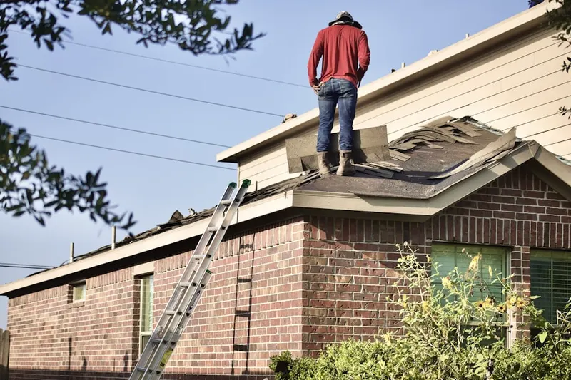 Professional roofer working on a residential roof in Crown Point
